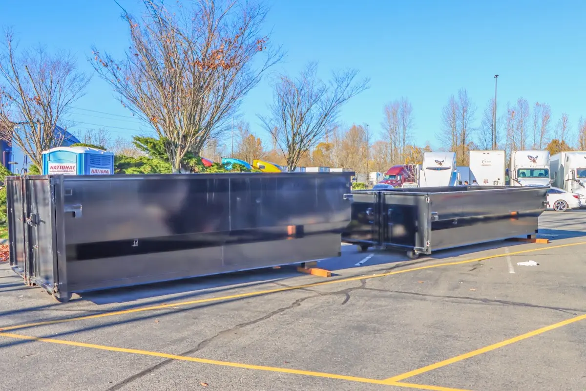 Professional dumpster rental service with roll-off container on residential driveway in Affton